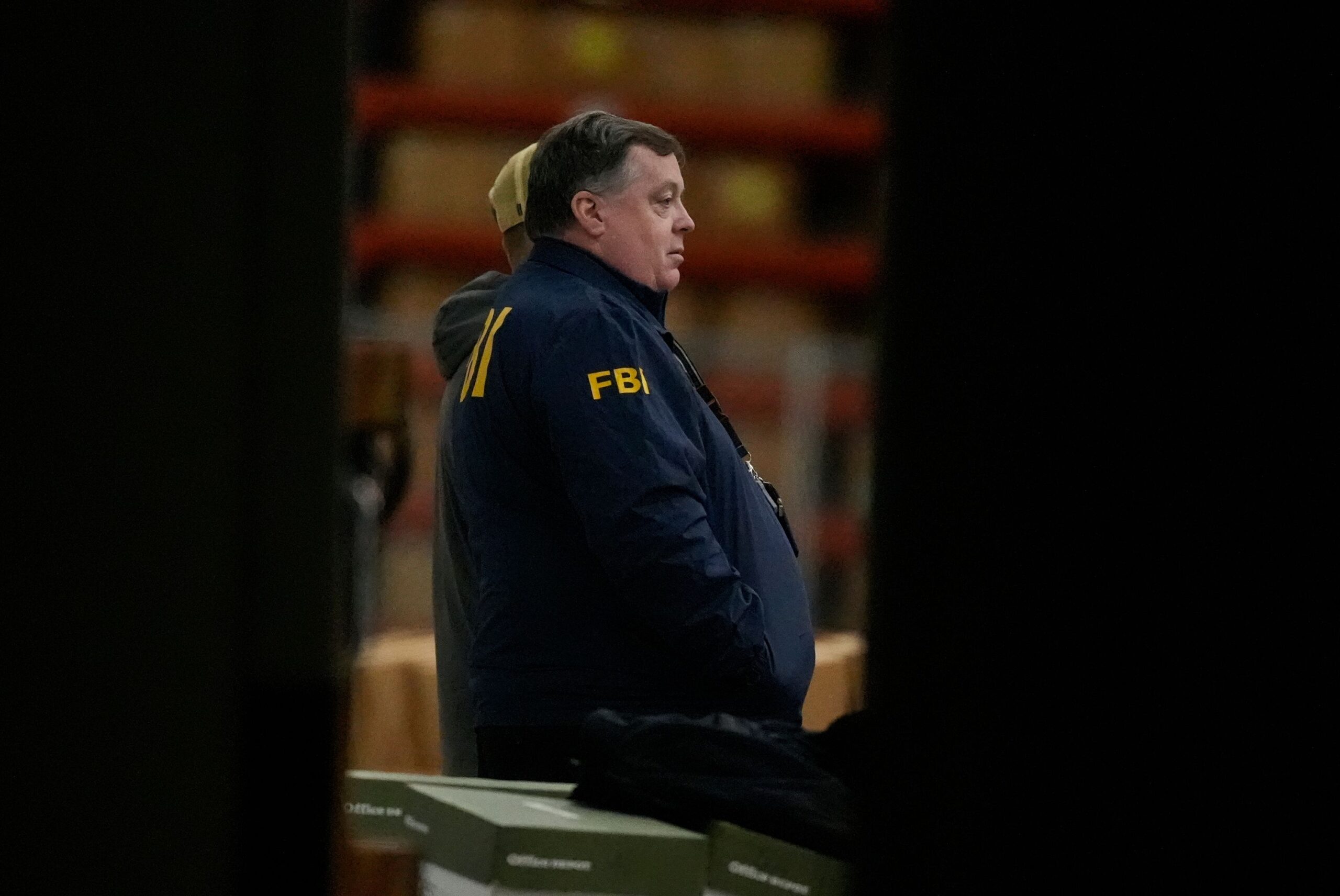 <i>Mike Stewart/AP via CNN Newsource</i><br/>An FBI employee stands inside the Fulton County Election Hub as the FBI takes Fulton County 2020 Election ballots