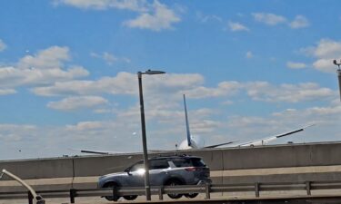A still image taken from video shows a United Airlines Boeing 767 landing at Newark Liberty International Airport after apparently damaging a streetlight and truck.