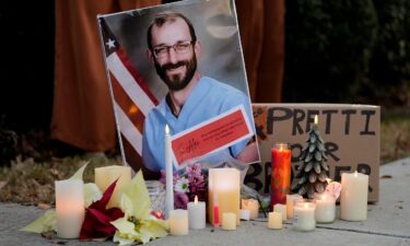 Becky Halioua holds a candle during a candlelight vigil for Alex Pretti