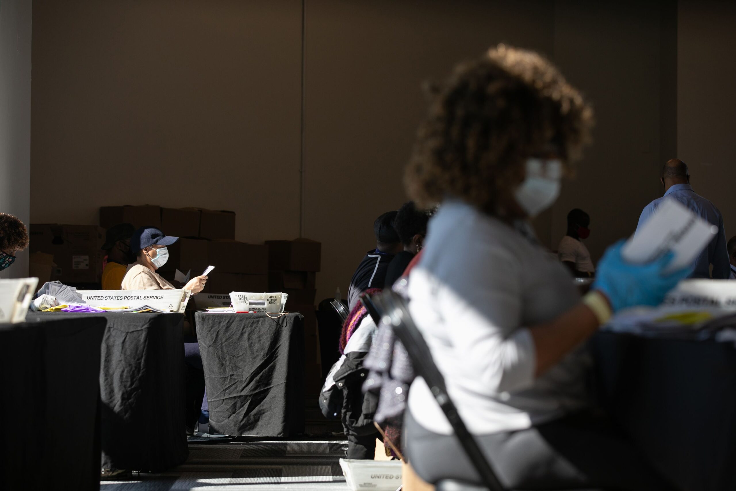 <i>Jessica McGowan/Getty Images via CNN Newsource</i><br/>Election workers count Fulton County ballots at State Farm Arena on November 4