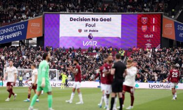 Arsenal fans react during the VAR review.
