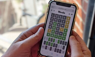 A person plays "Wordle" on a smartphone. NBC has just ordered a game-show version of the New York Times-owned mobile word game