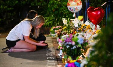 Students hold a vigil near the scene of a shooting near the Florida State University student center on April 17