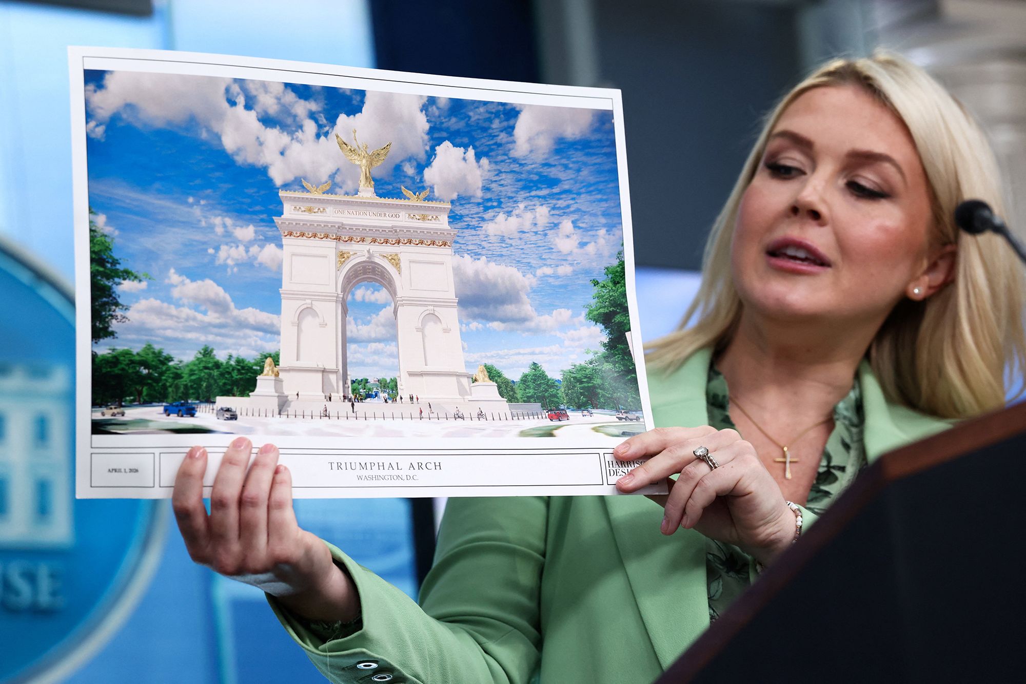 <i>Kevin Lamarque/Reuters via CNN Newsource</i><br/>White House Press Secretary Karoline Leavitt holds up a rendering of President Donald Trump's proposed arch during a press briefing in April.