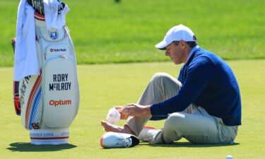Rory McIlroy tends to a blister on his right foot on the third hole during his practice round prior to the PGA Championship at Aronimink Golf Club.