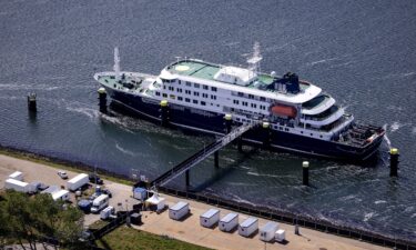 People in protective hazmat suits leave after inspecting the MV Hondius in Rotterdam on May 18.