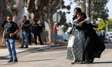 Two women react following the shooting at the Islamic Center of San Diego.