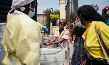 A visitor has their temperature checked before entering Kyeshero Hospital in Goma