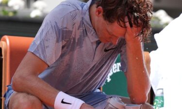 Jannik Sinner reacts as he cools himself with the water during a break at the second round men's singles tennis match against Juan Manuel Cerúndolo at the French Open in Paris on May 28