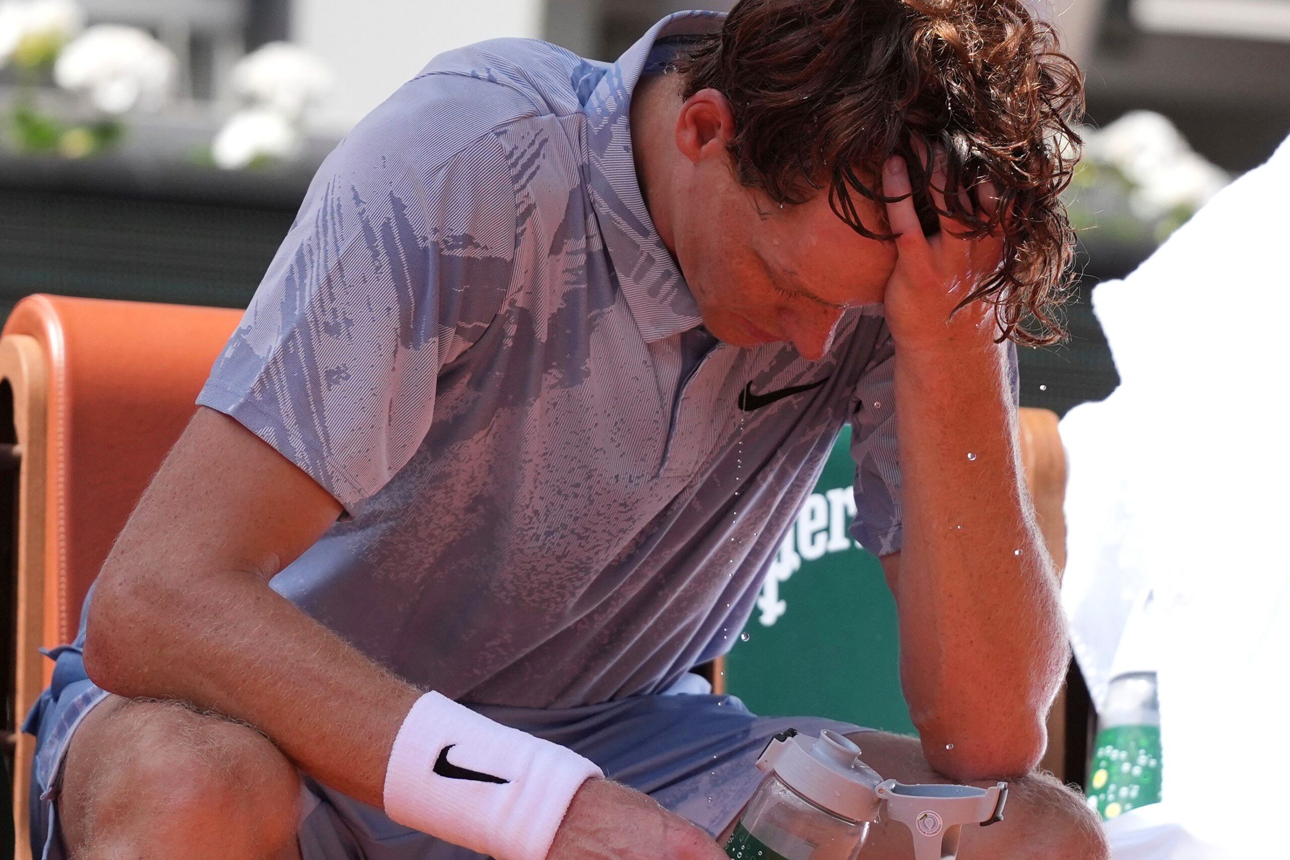 <i>Thibault Camus/AP via CNN Newsource</i><br/>Jannik Sinner reacts as he cools himself with the water during a break at the second round men's singles tennis match against Juan Manuel CerĂșndolo at the French Open in Paris on May 28
