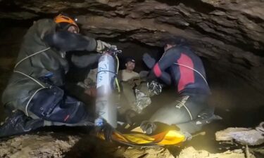 Divers from an international rescue team show the trapped villagers how to use diving equipment in Xaisomboun Province