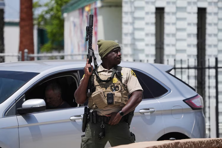 A sheriff's deputy stages at the scene of a shooting outside the Islamic Center of San Diego, May 18, 2026.
