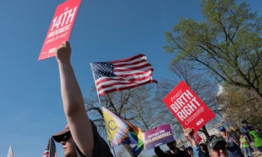 Demonstrators hold placards near the Supreme Court building in Washington
