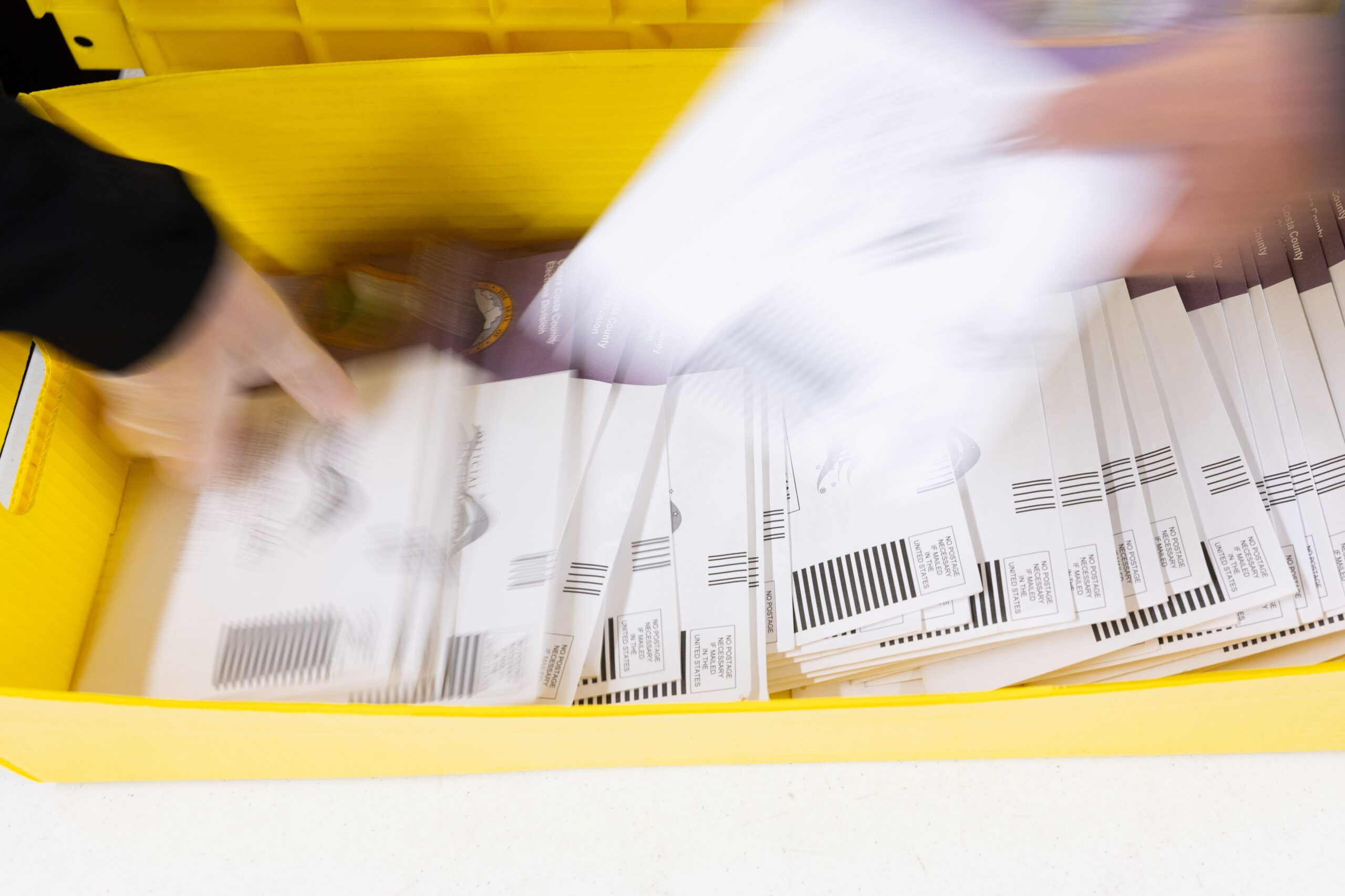 <i>Benjamin Fanjoy/Getty Images via CNN Newsource</i><br/>Election workers sort ballots at Contra Costa County's election operations facility on May 27 in Martinez