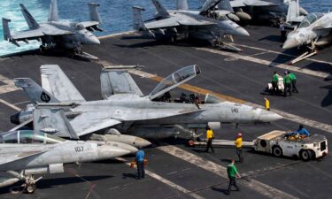 U.S. Sailors taxi an F/A-18F Super Hornet on the flight deck aboard Nimitz-class aircraft carrier USS Abraham Lincoln in support of Operation Epic Fury