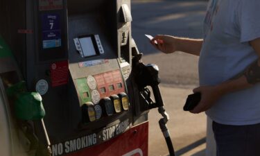 A driver pays at a fuel pump in Columbus