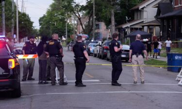 Police stand near where multiple people were shot at a community festival