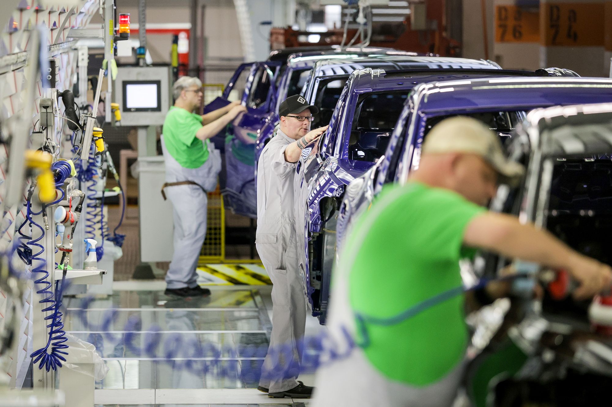 <i>Focke Strangmann/Getty Images via CNN Newsource</i><br/>Volkswagen workers check electric cars at one of the company's factories