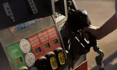 A driver finishes refueling a vehicle with regular gasoline at a GetGo gas station in Columbus