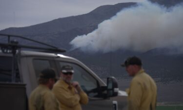 Firefighters gather near the Cottonwood Fire near Junction