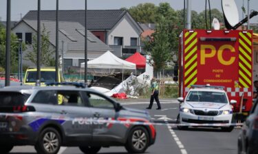 A rescuer works at the site of a plane crash in Tomblaine