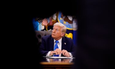 President Donald Trump sits at the Resolute desk after signing an executive order in Washington