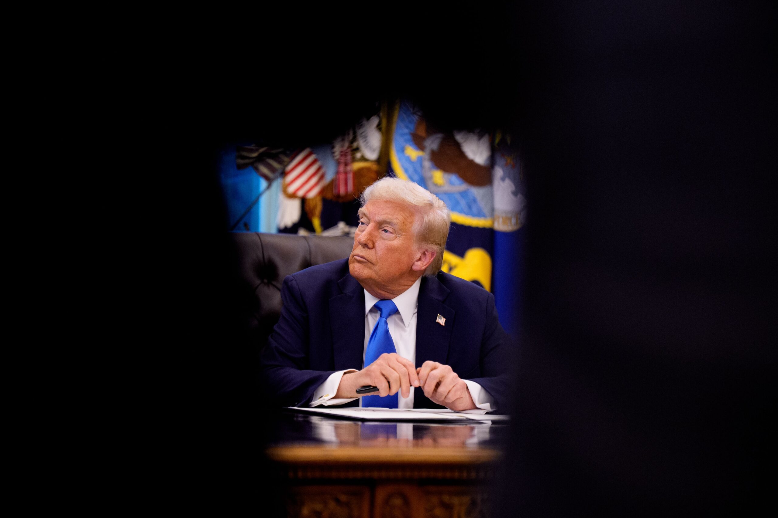 <i>Andrew Harnik/Getty Images via CNN Newsource</i><br/>President Donald Trump sits at the Resolute desk after signing an executive order in Washington