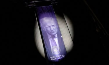 A banner featuring a picture of President Donald Trump is displayed at the United States Department of Justice building