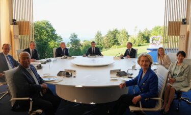 President Donald Trump talks with French President Emmanuel Macron at the G7 summit