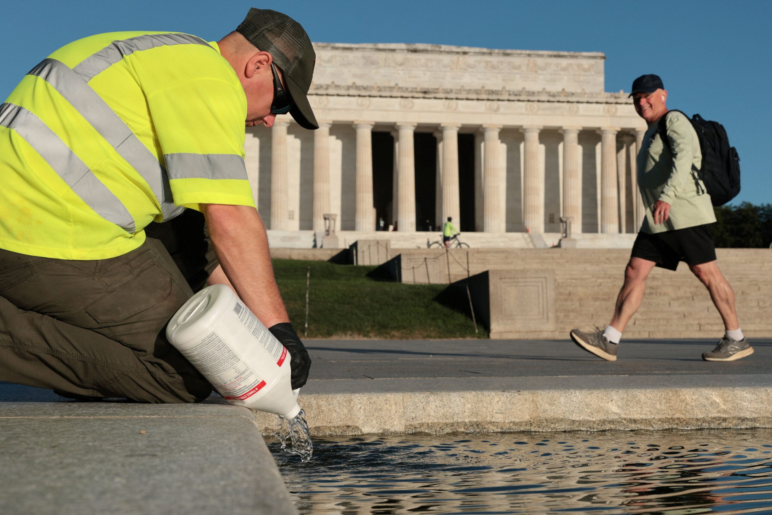 <i>Jonathan Ernst/Reuters via CNN Newsource</i><br/>A US National Park Service worker dumps bottles of hydrogen peroxide in the Lincoln Memorial Reflecting Pool as part of their effort to mitigate an algae bloom which followed the completion of recent renovations in Washington