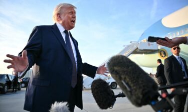 US President Donald Trump addresses the media on the tarmac after arriving at Paris Orly Airport enroute to a dinner to celebrate the 250th anniversary of the independence of the United States