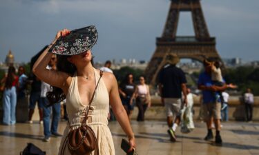 A woman on the Trocadero square near the Eiffel Tower as temperatures rise in Paris during a second heatwave affecting a large part of France