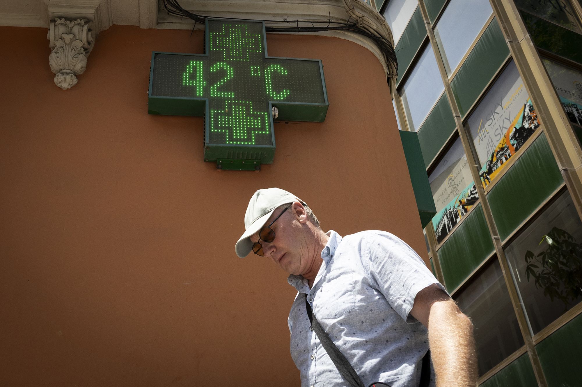 <i>Philippe Lopez/AFP/Getty Images via CNN Newsource</i><br/>A man sits on a camp bed at an emergency heatwave relief centre opened by the city of Bordeaux as France experiences a heatwave