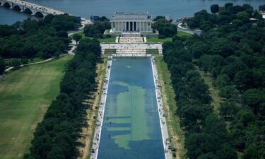 Chipped paint and algae are visible in the Lincoln Memorial Reflecting Pool