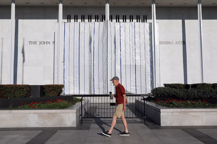 The wall of the John F. Kennedy Center for the Performing Arts is covered in tarp after President Donald Trump's name was removed, in Washington, June 13, 2026.
