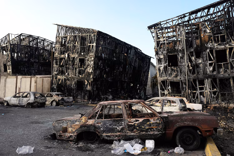 Houses damaged and burned by fires following the earthquakes stand in Catia La Mar, Venezuela, three days later, on June 27, 2026.