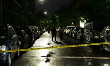 NYPD officers work at the scene where eight people