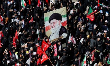Mourners chant while holding flower-framed portraits of the slain Iranian Supreme Leader Ayatollah Ali Khamenei during his funeral procession in Tehran