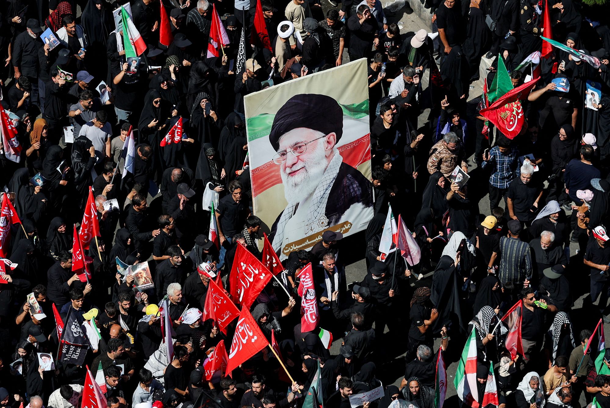 <i>Altaf Qadri/AP via CNN Newsource</i><br/>Mourners chant while holding flower-framed portraits of the slain Iranian Supreme Leader Ayatollah Ali Khamenei during his funeral procession in Tehran