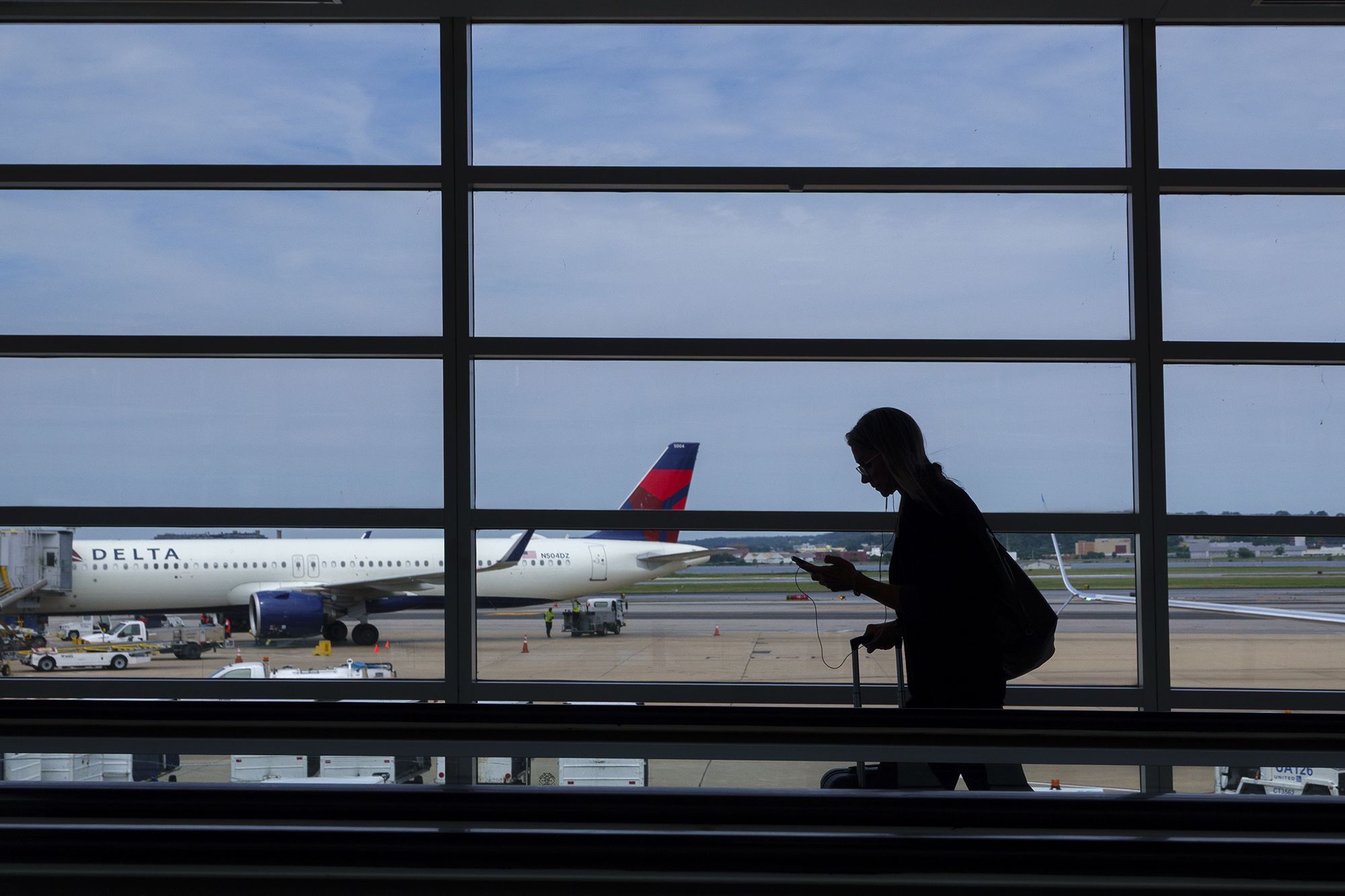 <i>Kevin Carter/Getty Images via CNN Newsource</i><br/>A passenger walks through the terminal at Ronald Reagan Washington National Airport. Strong demand for travel should keep airfares high the rest of this year