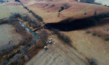 Crews clean the area where the ruptured Keystone pipeline dumped oil into a creek in Washington County