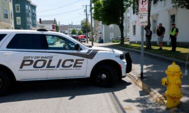 A police vehicle is parked near a scene of a shooting involving US Immigration and Customs Enforcement in Biddeford