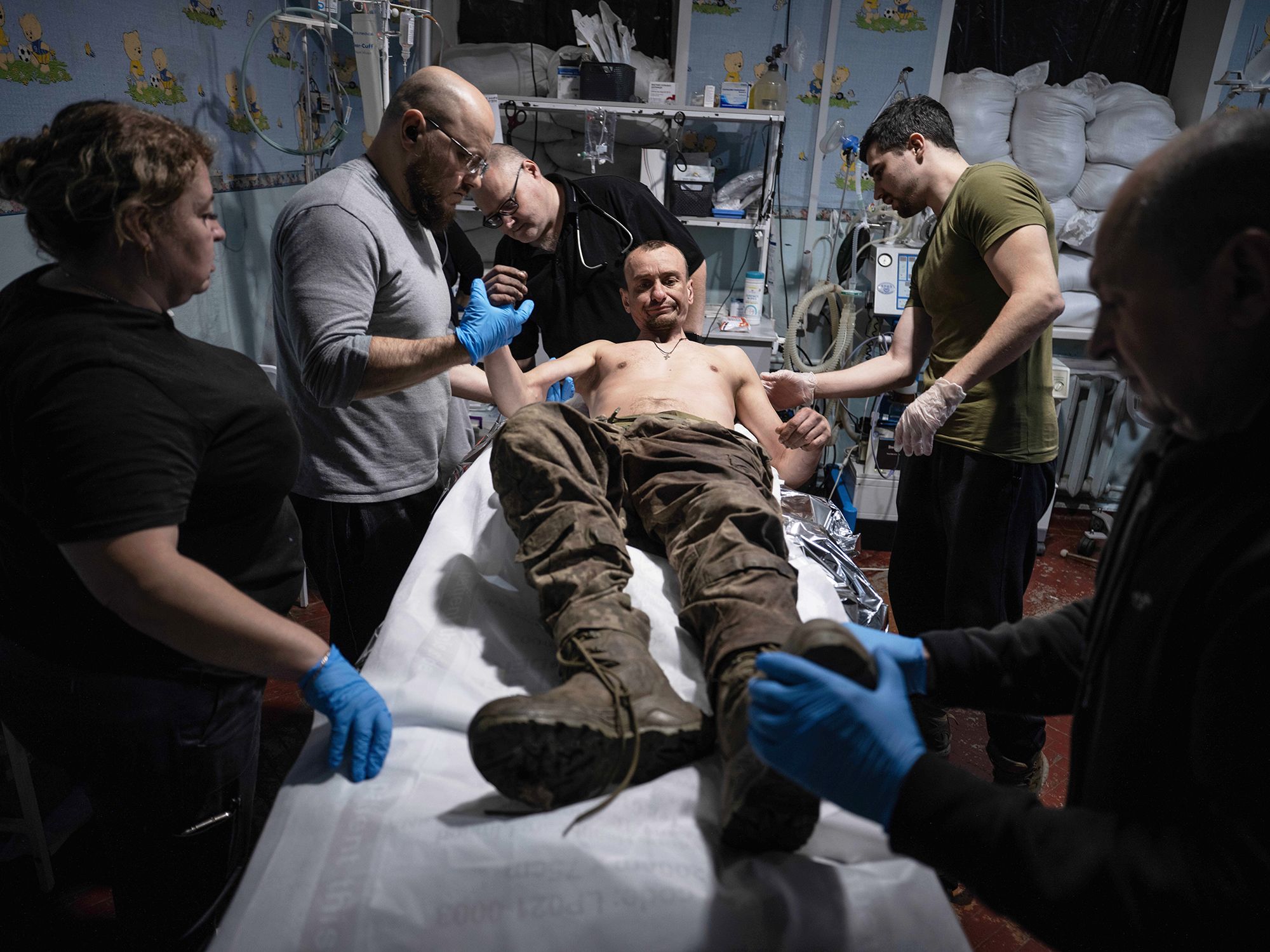 <i>Iryna Rybakova/Ukraine's 93rd Mechanized Brigade/AP via CNN Newsource</i><br/>Military medics give first aid to a wounded soldier at a stabilisation point near Kostyantynivka in November 2025.