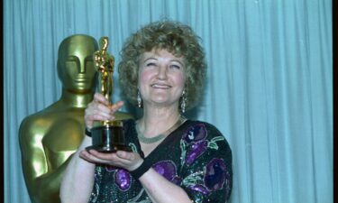 Brenda Fricker holds up her Oscar after winning Best Supporting Actress for her role in "My Left Foot" in 1990.