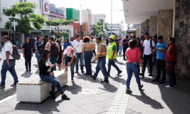 People evacuate a building after a powerful 7.4-magnitude earthquake struck off the coast of Mexico's southern state of Chiapas