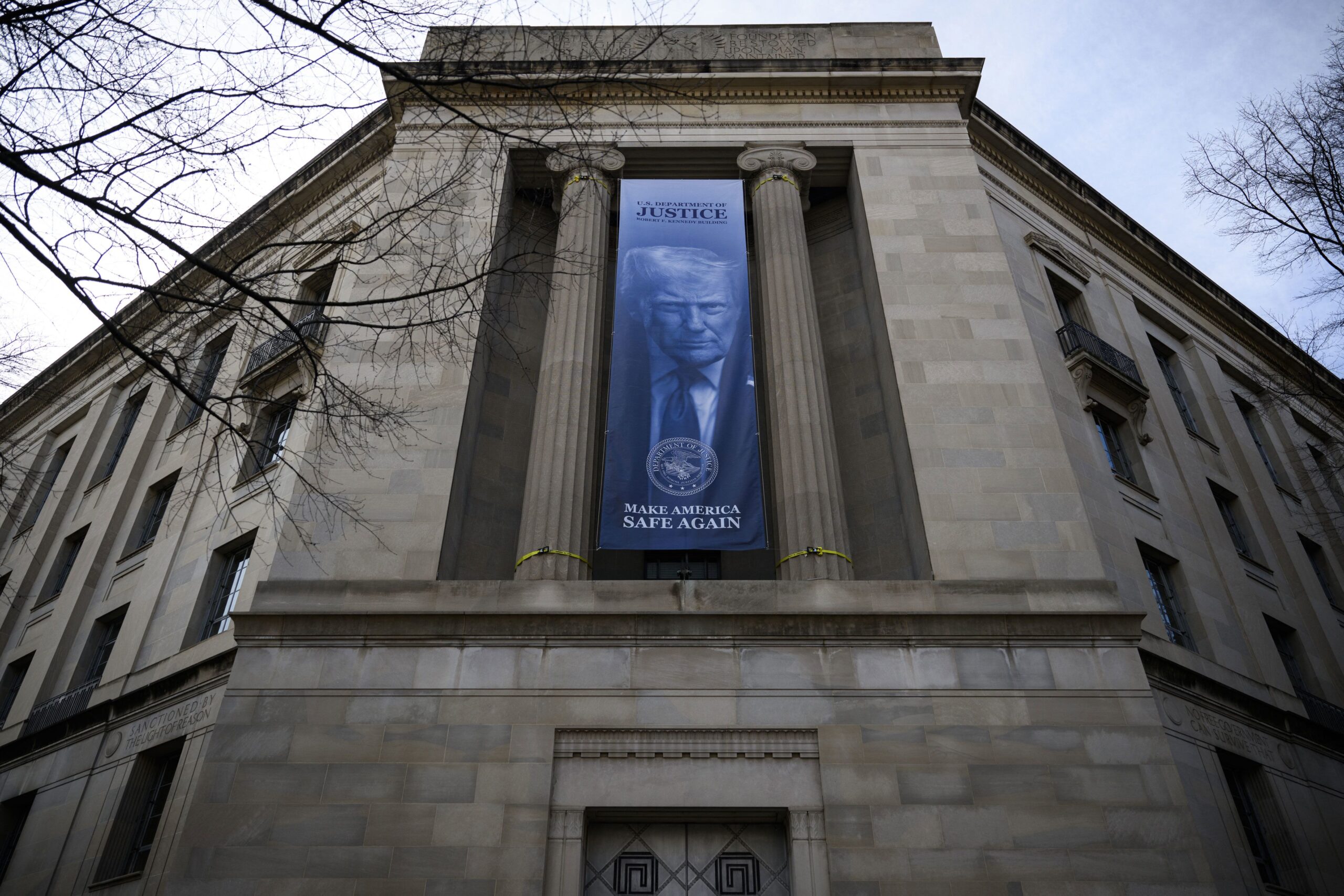 <i>Drew Angerer/AFP/Getty Images via CNN Newsource</i><br/>A a new banner featuring an image of US President Donald Trump is displayed on the facade of the US Department of Justice headquarters
