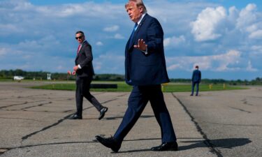 President Donald Trump walks off Air Force One at the Morristown Municipal Airport on July 31