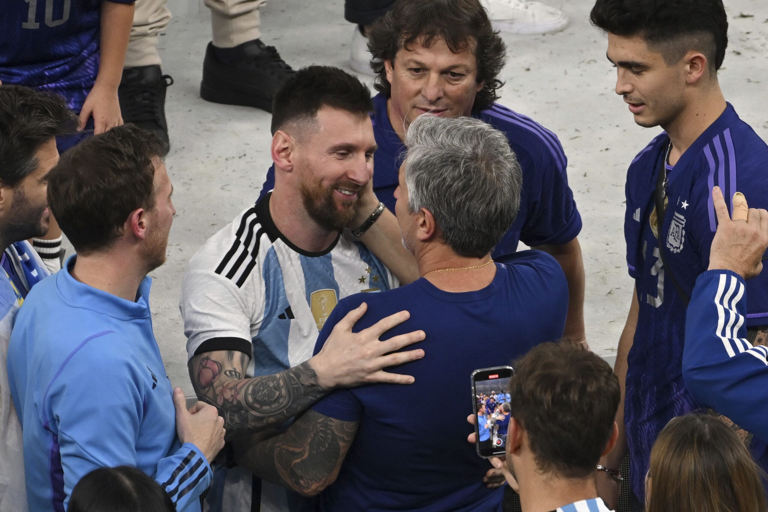 Argentina's Lionel Messi celebrates with his father Jorge Messi following his team's win during 2022 FIFA World Cup final match against France at Lusail Stadium in Qatar on December 18. 2022.