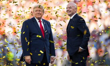 Infantino shows Trump the men's World Cup Trophy in the Oval Office as Vice President JD Vance looks on.