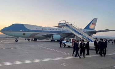 A catering truck is parked on the other side of Air Force One